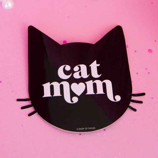 Black cat-shaped sticker with 'cat mom' text on a pink background