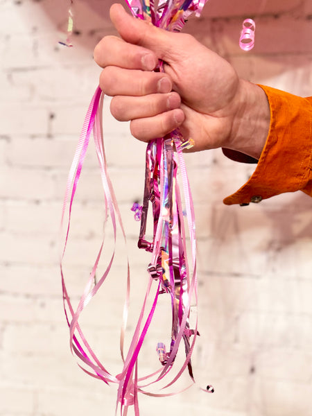 Pink helium balloon bouquet balloon tails streamers close up