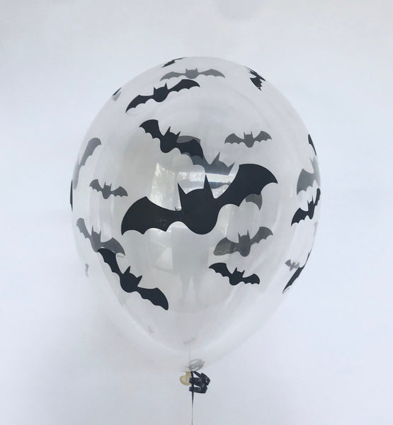 An 11-inch clear round balloon with a pattern of black bats printed on it, with a visible latex texture and a string attachment at the bottom. 11 inch clear bat printed balloon halloween spooky pick up or delivery Pittsburgh Lawrenceville